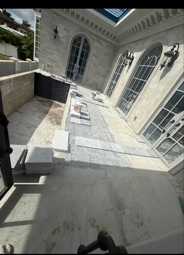 Pool deck under construction with the surface prepared for pavers