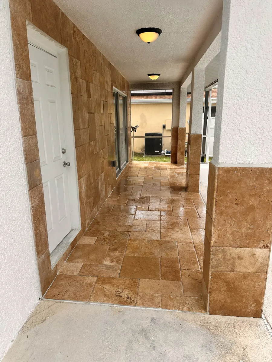Hallway floored in travertine by B2B Construction, running through to the back of the house